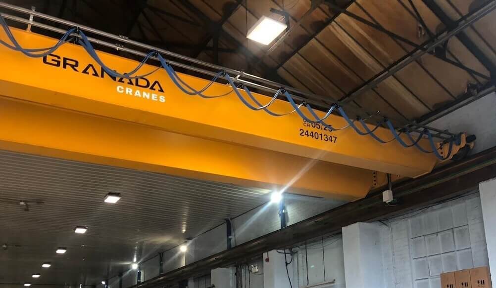 Double girder overhead crane lifting a load